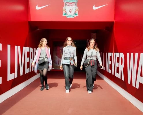 Anfield stadium tour showing the tunnel with group of 3 female friends